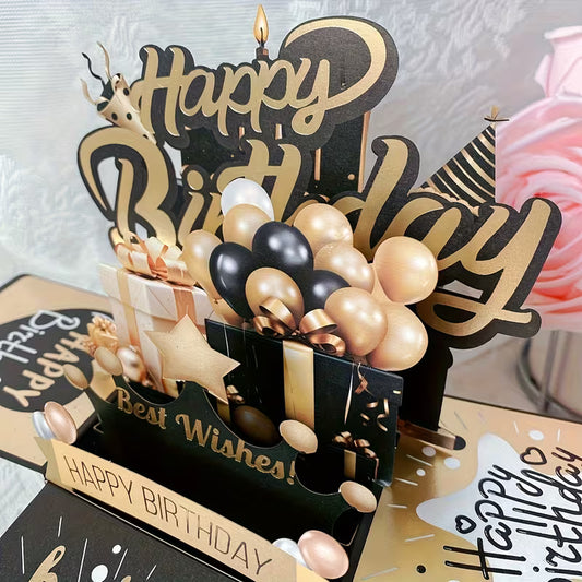 3D pop-up születésnapi kártya fekete-arany kivitelben — lufik, ajándékdobozok, gyertya, Happy Birthday felirat közelről